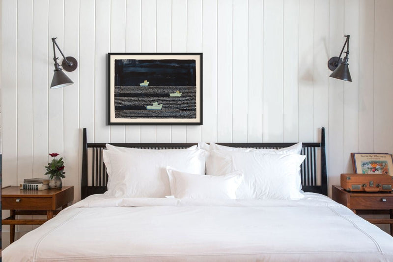 nautical inspired art print featuring fishing boats heading back to harbour on a bedroom wall