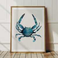 crab painting framed in wooden frame in a white painted room