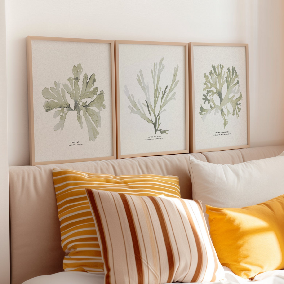 set of three green seaweed prints on wall above bed