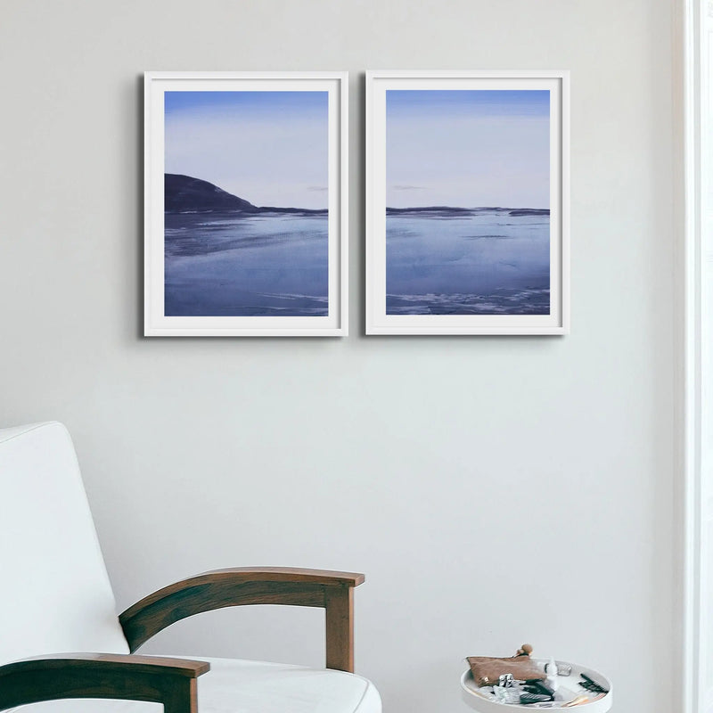 a set of two moody paintings at dawn on a beach near Padstow above a white chair and small table - Beach House Art