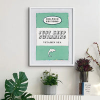 ramed book cover poster with white frame - Just keep swimmong is written in large font in the centre and is perfect for wild swimmers or cold water swimming enthusiasts