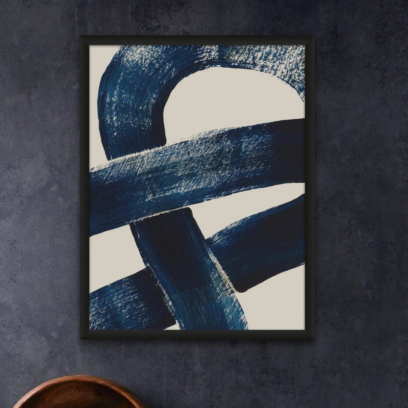 Wall art of a knot in a black frame against a dark grey wall interior