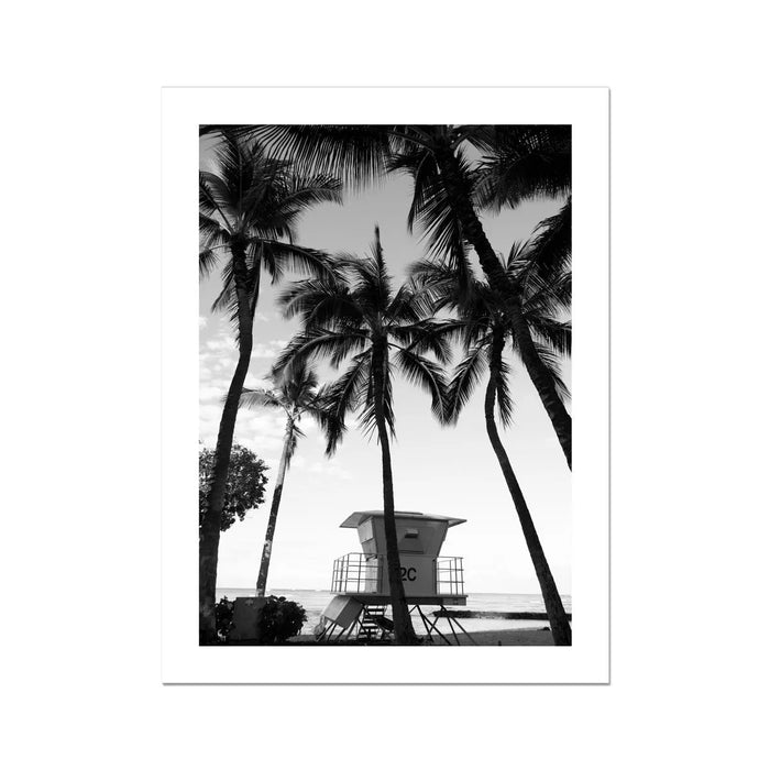 black & white beach art photograph of a life savers lookout in a palm tree grove - beach house art