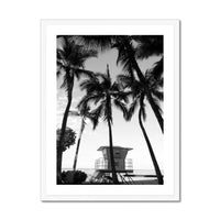 black & white beach art photograph of a life savers cabin in a palm tree grove in a white frame - beach house art