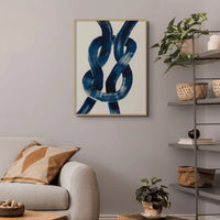 wall art print of a navy reef knot on a beige background in a small living room