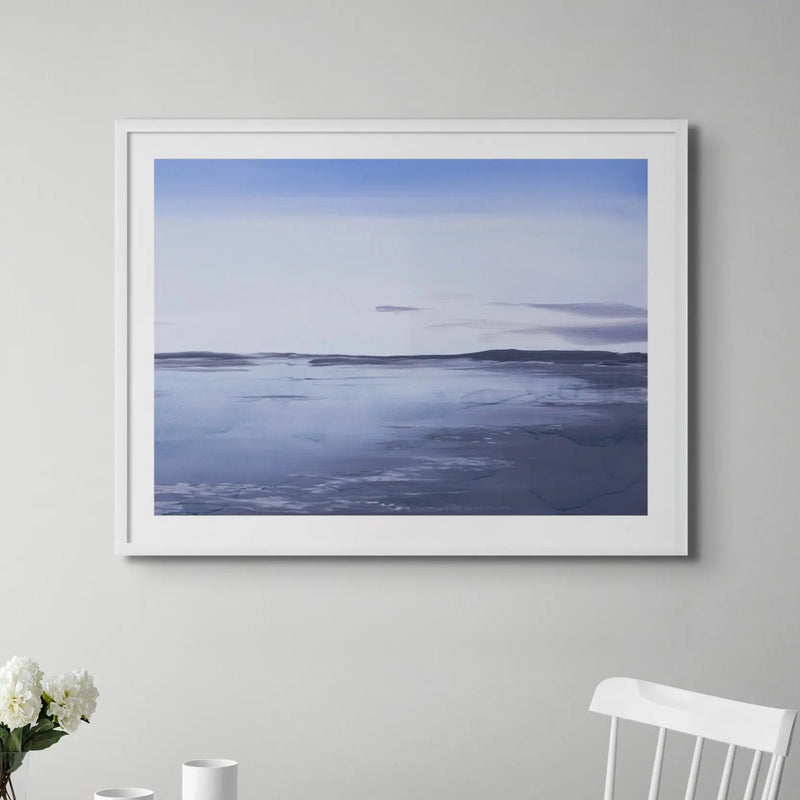 a painted seascape of a sunrise above Padstow in a clean, modern white dining room - beach house art