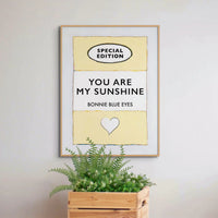 Beach House Art | You Are My Sunshine | Lyric Book Cover Art Print in white frame above a plant