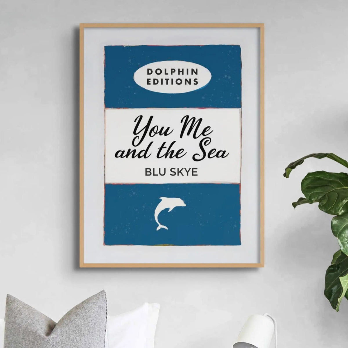 framed book cover print in blue with you me and the see in bold type in centre